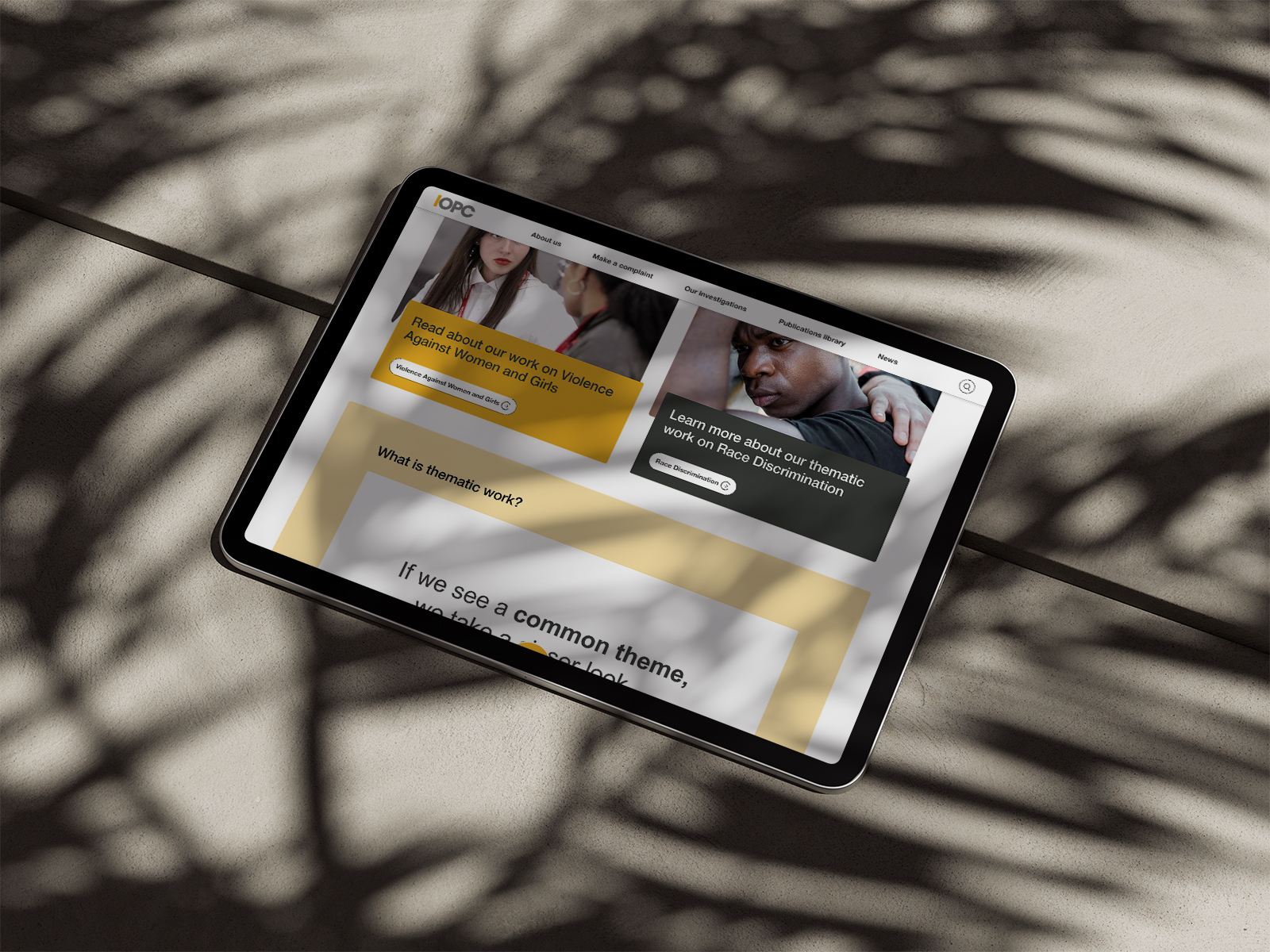 Tablet screen showing IOPC website with sections on Violence Against Women and Girls and Race Discrimination.